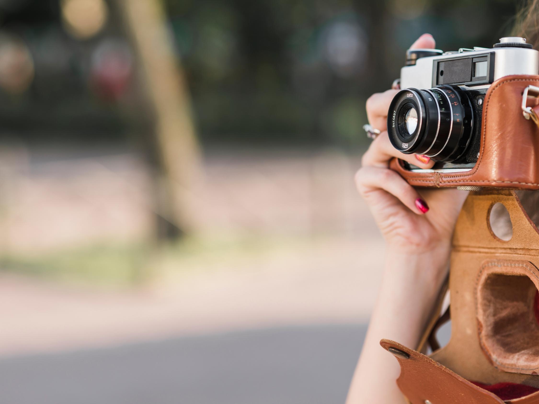 hand-taking-picture-old-camera